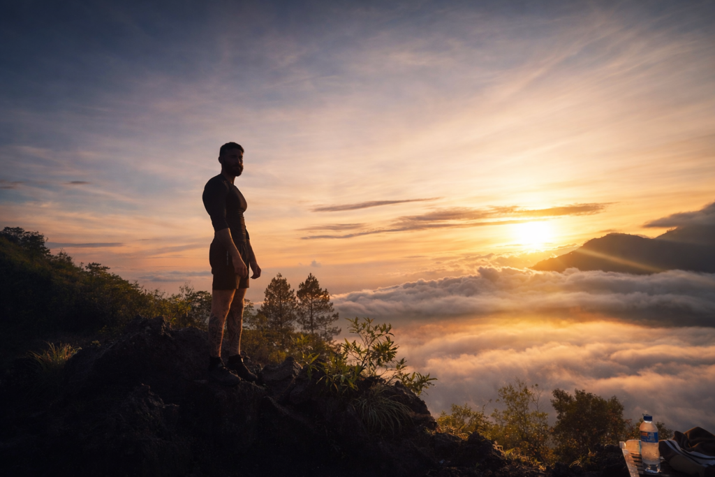 Hikers trekking Mount Batur before sunrise with headlamps on the volcanic trail, Kintamani, Bali